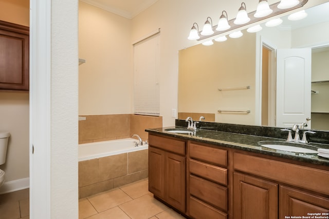 bathroom featuring vanity, crown molding, tiled tub, tile patterned flooring, and toilet