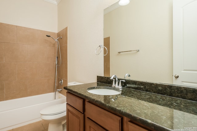 full bathroom featuring tile patterned flooring, toilet, vanity, and tiled shower / bath