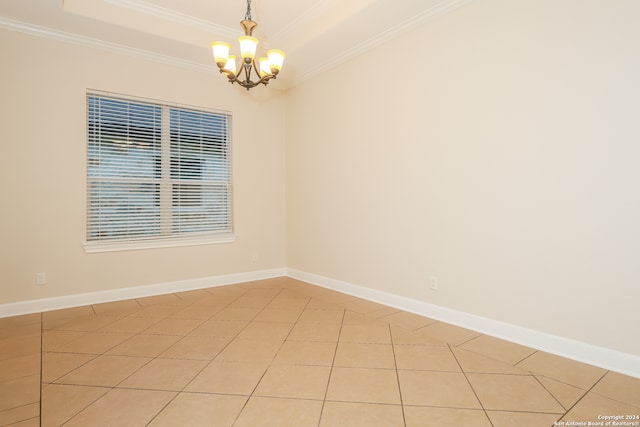 tiled spare room with crown molding and a chandelier