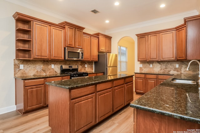 kitchen with backsplash, sink, a center island, and appliances with stainless steel finishes