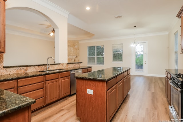 kitchen with stainless steel appliances, a kitchen island, light hardwood / wood-style floors, and sink