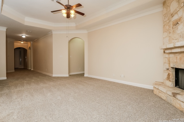 unfurnished living room featuring carpet, a raised ceiling, and crown molding