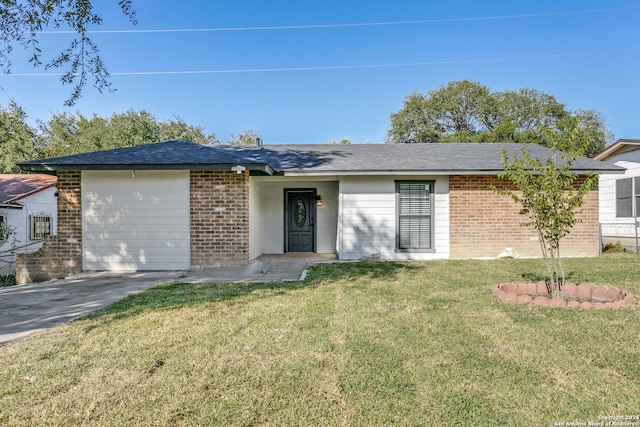 ranch-style house featuring a garage and a front lawn