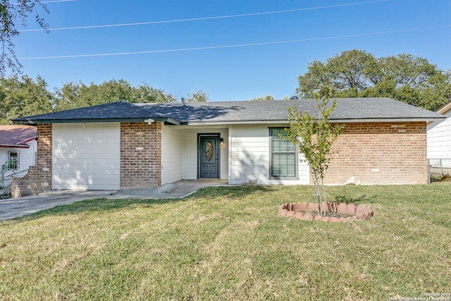 ranch-style home featuring a garage and a front yard