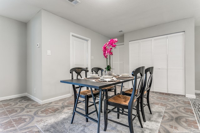 dining space with a textured ceiling