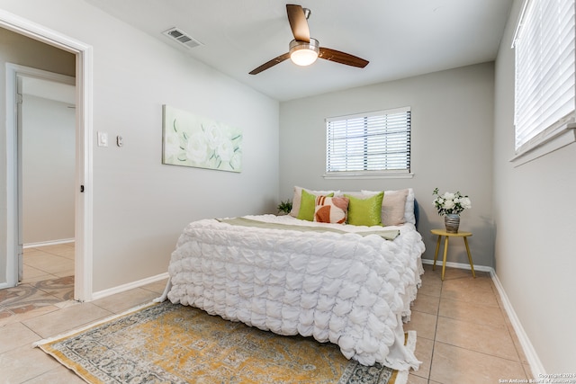 tiled bedroom with ceiling fan