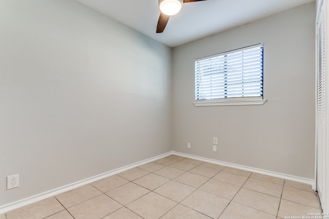 empty room featuring light tile patterned floors and ceiling fan