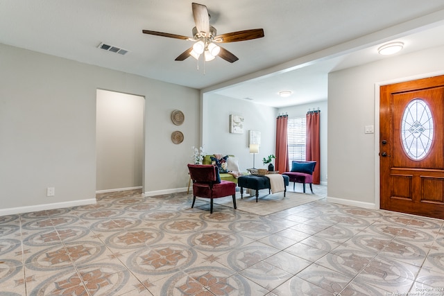 tiled entrance foyer featuring ceiling fan