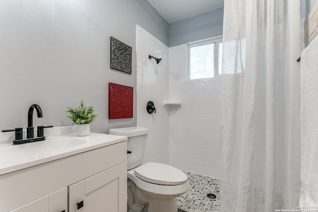 bathroom featuring vanity, toilet, and walk in shower