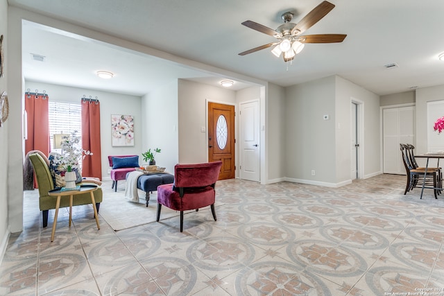 interior space with ceiling fan