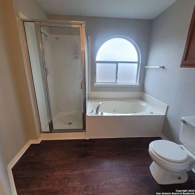 bathroom featuring toilet, wood-type flooring, and shower with separate bathtub