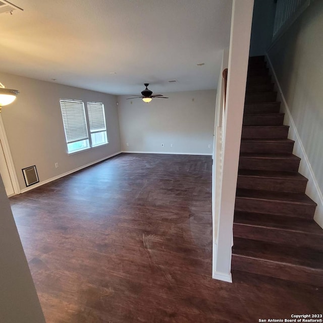 interior space with ceiling fan and dark wood-type flooring