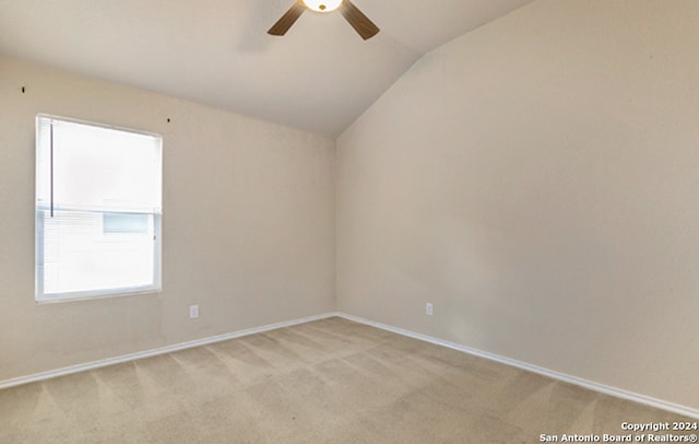 carpeted empty room with ceiling fan and lofted ceiling