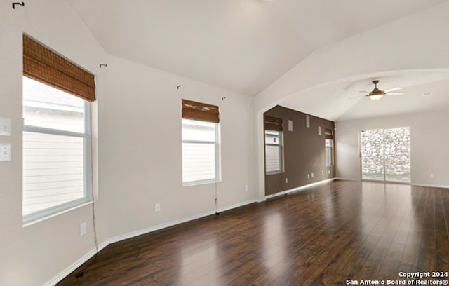 unfurnished room featuring plenty of natural light and dark wood-type flooring