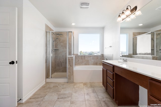 bathroom with plus walk in shower, vanity, and tile patterned flooring