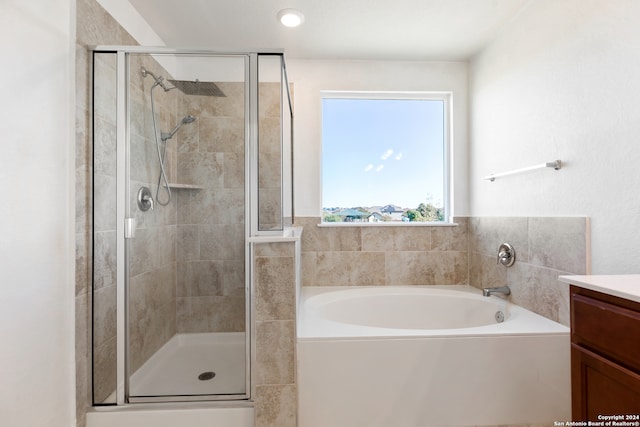 bathroom featuring separate shower and tub and vanity