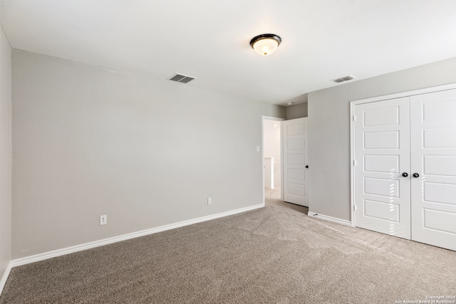 unfurnished bedroom featuring a closet and carpet floors