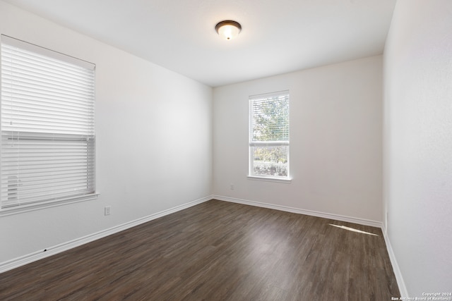 empty room with dark hardwood / wood-style floors