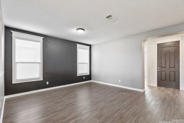 spare room with dark wood-type flooring