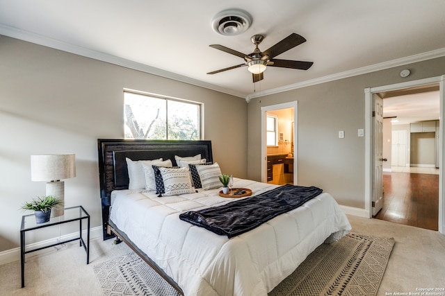 bedroom with light wood-type flooring, ensuite bathroom, ceiling fan, and crown molding