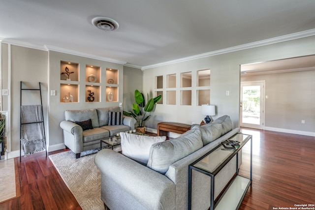 living room featuring crown molding, hardwood / wood-style floors, and built in features