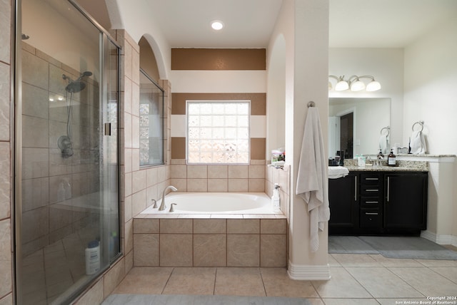 bathroom featuring tile patterned floors, vanity, and plus walk in shower