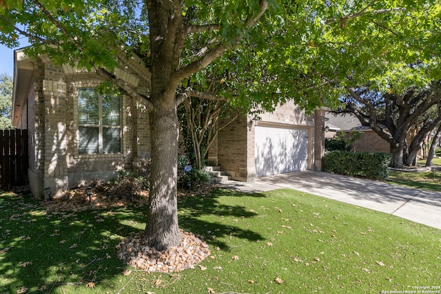 obstructed view of property featuring a front yard and a garage