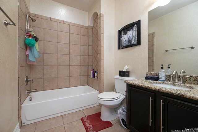 full bathroom with vanity, tiled shower / bath combo, tile patterned floors, and toilet