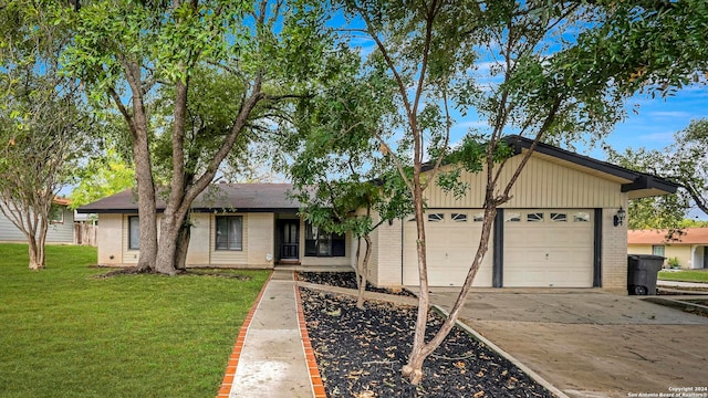 single story home featuring a front yard and a garage