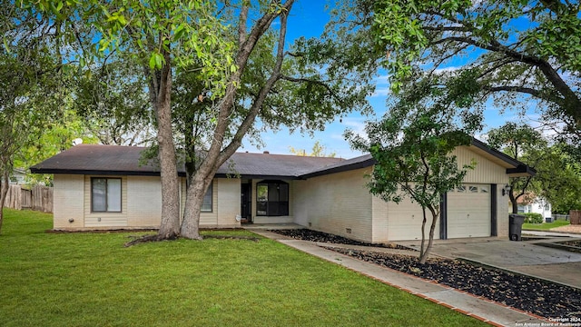 ranch-style home with a front yard and a garage