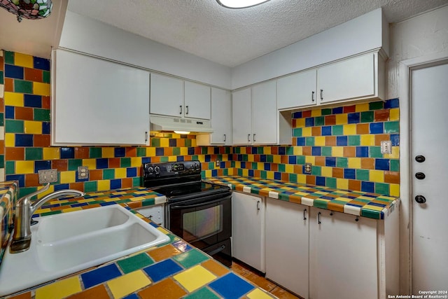 kitchen with black electric range, white cabinetry, and sink