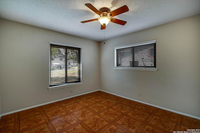 unfurnished room featuring a textured ceiling and ceiling fan