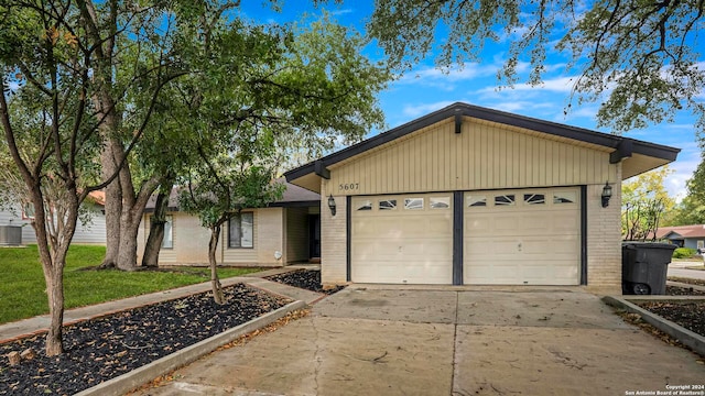 ranch-style home with central air condition unit and a front lawn