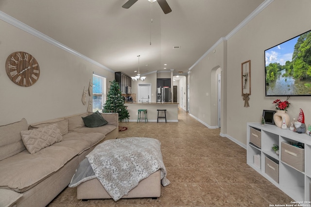 living room featuring vaulted ceiling, ceiling fan with notable chandelier, and ornamental molding