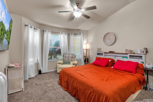 bedroom with ceiling fan, light colored carpet, and vaulted ceiling