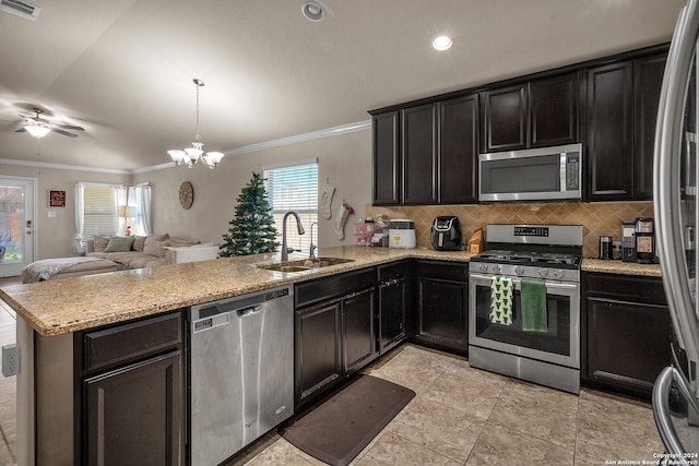 kitchen with crown molding, kitchen peninsula, sink, and appliances with stainless steel finishes