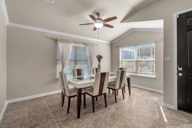 dining area with ceiling fan, lofted ceiling, and ornamental molding