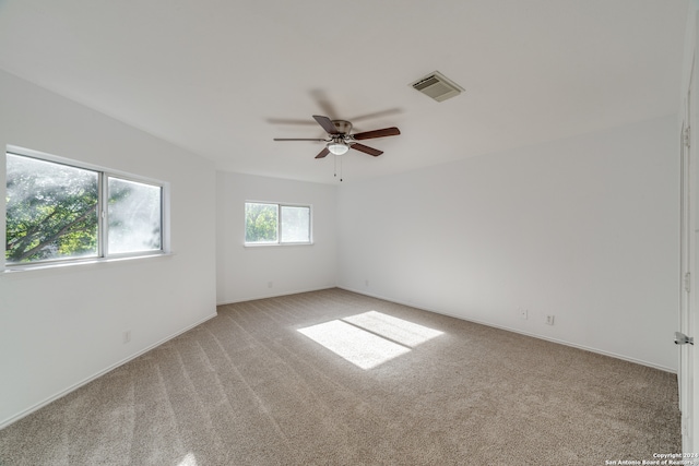 carpeted empty room featuring ceiling fan