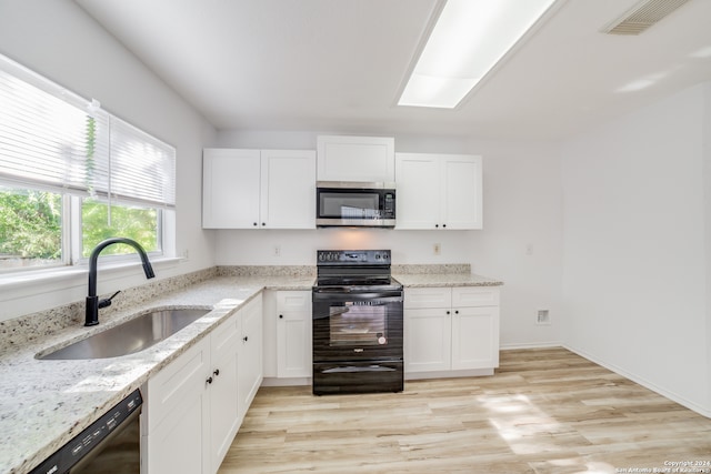 kitchen featuring black appliances, white cabinets, sink, and light hardwood / wood-style flooring