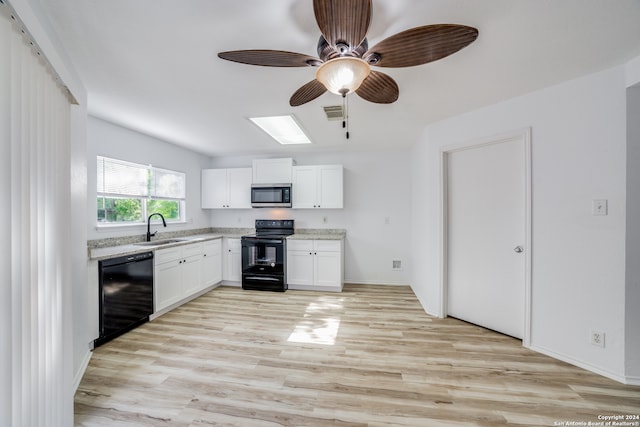 kitchen with white cabinetry, sink, black appliances, and light hardwood / wood-style flooring