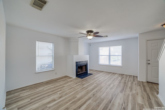 unfurnished living room featuring ceiling fan and light hardwood / wood-style flooring