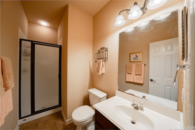 bathroom featuring vanity, an enclosed shower, and toilet