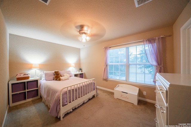 carpeted bedroom with a textured ceiling and ceiling fan