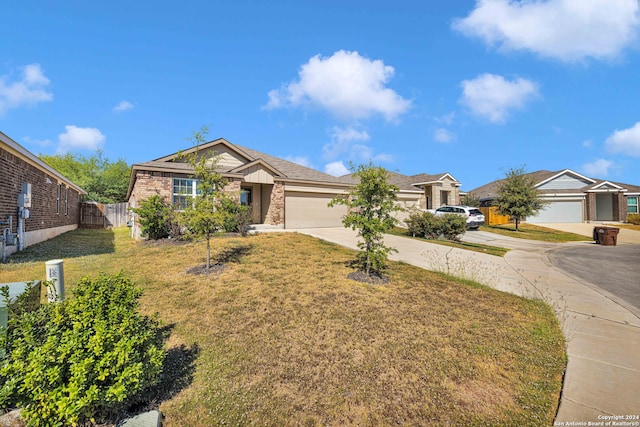 single story home featuring a front lawn and a garage