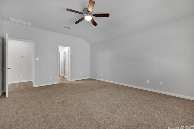 carpeted spare room with vaulted ceiling and ceiling fan