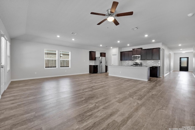 8559 Laxey Wheel, San Antonio, TX 78254 - unfurnished living room with ceiling fan, light wood finished floors, baseboards, and recessed lighting