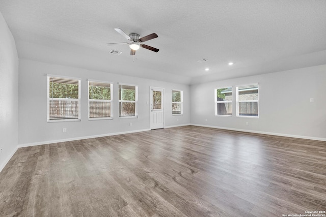 8559 Laxey Wheel, San Antonio, TX 78254 - empty room with wood finished floors, a ceiling fan, baseboards, a textured ceiling, and recessed lighting