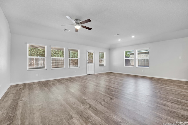 unfurnished living room with hardwood / wood-style floors and a textured ceiling