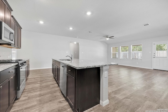 8559 Laxey Wheel, San Antonio, TX 78254 - kitchen with appliances with stainless steel finishes, ceiling fan, baseboards, light wood-style flooring, and recessed lighting