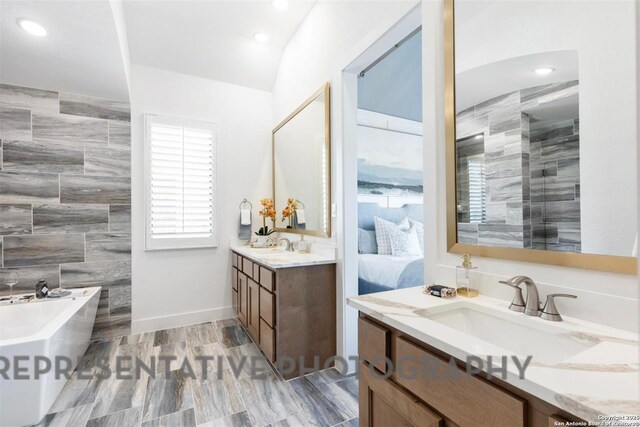 11714 Warlock, San Antonio, TX 78254 - ensuite bathroom featuring ensuite bathroom, a sink, a freestanding tub, two vanities, and recessed lighting